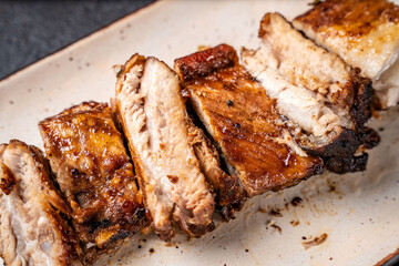 Grilled pork ribs sliced on plate