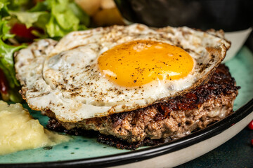 Grilled beef patty with fried egg