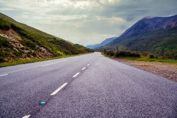 Empty country road through a valley, Scotland © atosan