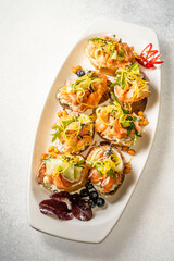 Gourmet bruschetta with salmon and fresh vegetables