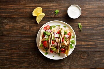 Tacos with vegetables and meat on wooden background