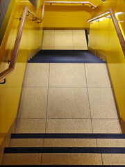 yellow stairs in the hall with yellow light