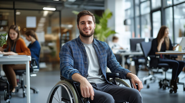 A young professional man in a wheelchair working in a modern office, collaborating with colleagues
