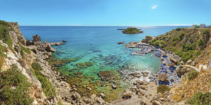 Grande Blue Bay with clear, turquoise-coloured water and rocks in sunny weather, Grande Blue Beach, Stegna, Archangelos, Rhodes Island, Greece