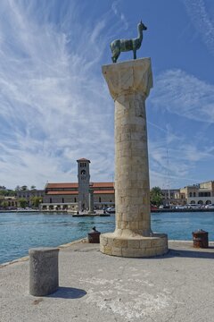 Colossus of Rhodes rises at the harbour of Mandraki, Colossus of Rhodes Mandraki Harbour, Medieval Town of Rhodes, Rhodes Island, Greece