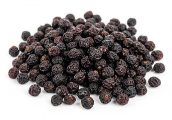 Obraz premium A large pile of small, dried berries rests on a white surface, their dark, wrinkled skins creating a rich texture. They appear ready for use in a recipe.