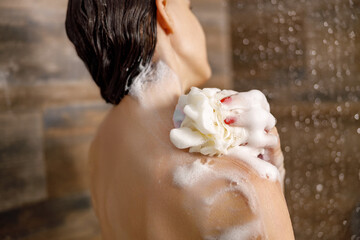 In this tranquil moment of selfcare, a person is delightfully soaking in a wonderfully foamy shower