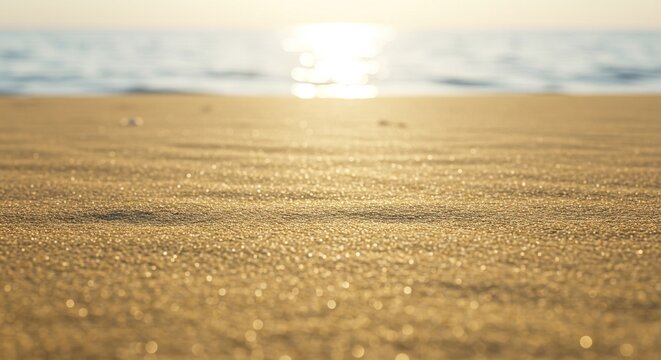 Golden hour glow illuminates the pristine sandy beach as soft ocean waves gently caress the shore, creating a tranquil and picturesque natural landscape