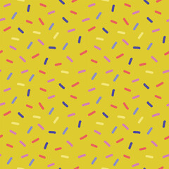 Fun seamless colorful confetti pattern on yellow background for gift packaging, birthday cards, playful wrapping paper and festive decor
