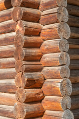 Corner of a traditional wooden log house with interlocked beams.