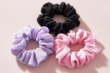Three Pastel-Colored Scrunchies on Plain Background – Hair Accessory Product Photography.