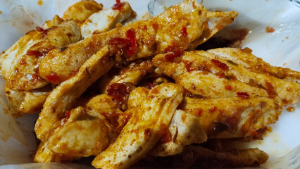 A combination of crispy fried fish otak-otak covered in traditional chili sauce that makes it...