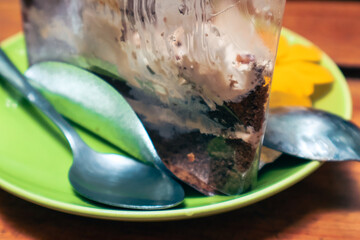 Playful kitten exploring a vibrant green plate, curious feline with shiny cutlery, perfect for food-related themes.