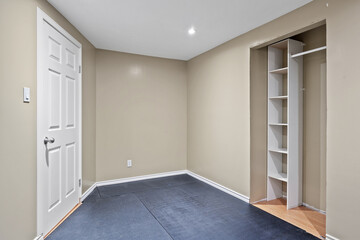 Small room with a white door and a white closet