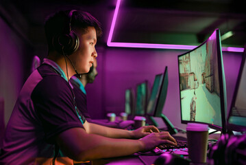 A dedicated gamer immersed in esports, showcasing enthusiasm in a vibrant neon atmosphere reflecting gaming