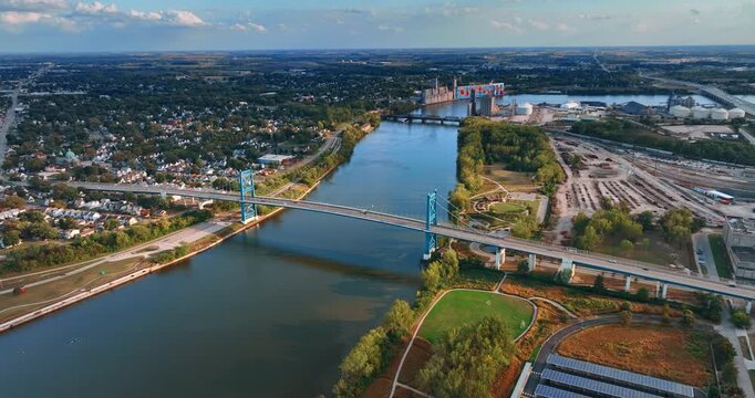 The Anthony Wayne Bridge or High Level Bridge with cars riding by. Traffic across the Maumee River in Toledo, Ohio, USA at daytime. Aerial view.