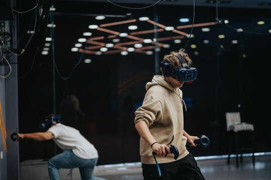 Two friends explore an immersive virtual reality environment, wearing VR headsets and controllers in a modern tech-friendly space, enjoying a cutting-edge gaming session.