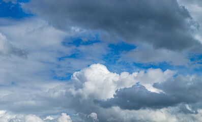 A beautiful white cumulus cloud is illuminated by the sun