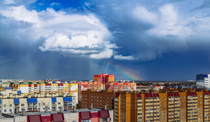 Amazing cloudy landscape above multi-colored residential buildings