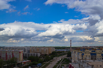 Panoramic cityscape with clouds and apartments