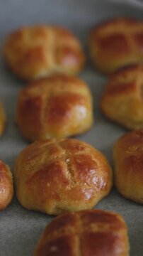 Close-Up of Mini Doughnut-Shaped Breads Baked on a Tray with Parchment Paper
