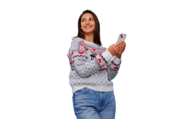 Woman wearing festive christmas sweater holding smartphone, smiling, looking away on transparent background