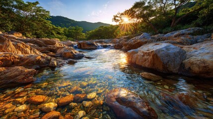 Crystal clear stream flowing amidst rocks at sunrise.