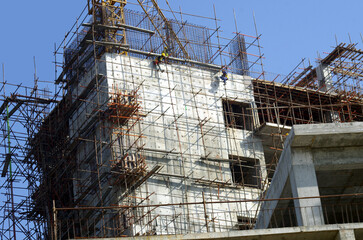 constructing high rise building with exterior scaffolds  © Ayesha