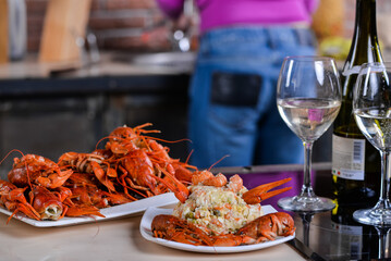 plate with crayfish nta plate of olivier with crayfish necks in the background girl