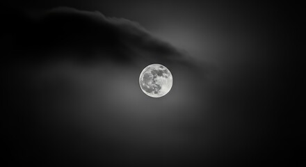 Bright Full Moon Illuminating Dark Night Sky with Clouds in Black and White