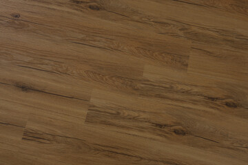 Fototapeta premium Golden oak laminate floor with visible knots and subtle highlights, offering a warm natural backdrop for interior decor or construction projects.