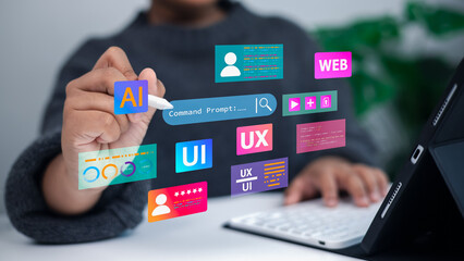 Designer working on tablet with UI UX AI web development technology interface concept