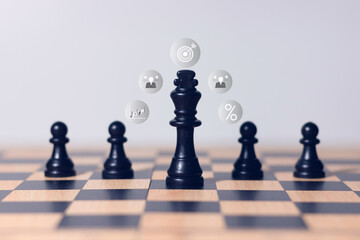 Black chess king surrounded by pawns on wooden chessboard, symbol of leadership, teamwork, business...