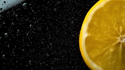Close-up of a fresh lemon slice submerged in sparkling water, creating bubbles and a refreshing atmosphere