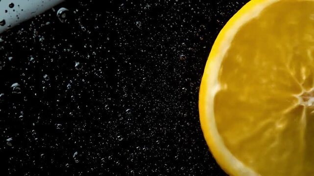 Close-up of a fresh lemon slice submerged in sparkling water, creating bubbles and a refreshing atmosphere
