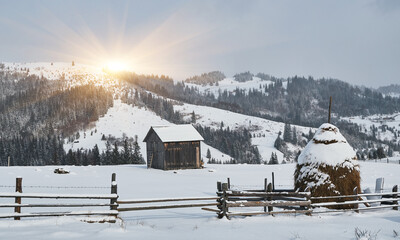 Rustic farm scene with a haystack in winter.