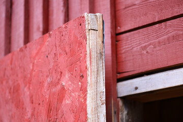 A close-up view of a wooden surface with the iconic red building in the background
