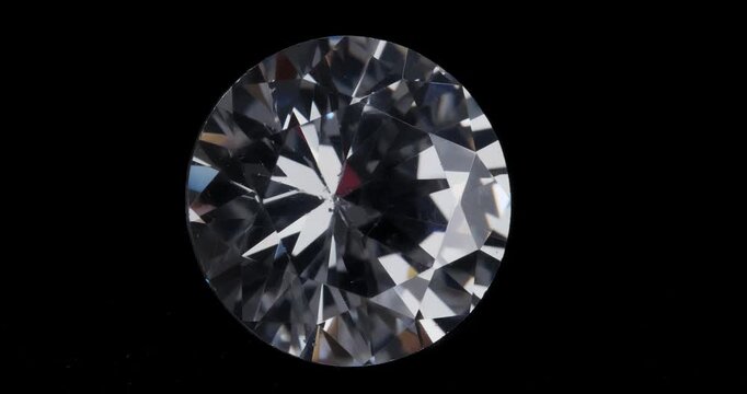 Jewelry zirconia stone on a dark background. Artificial gemstone on a rotating table.