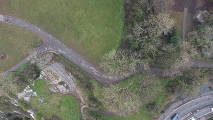 Top down lanscape of an urban park on a rainy day. Water stained pathways snake among bare trees