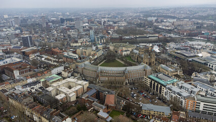 Aerial view of Bristol city centre featuring City Hall, College Green, and the Cathedral, with the harbourside and skyline in the distance.