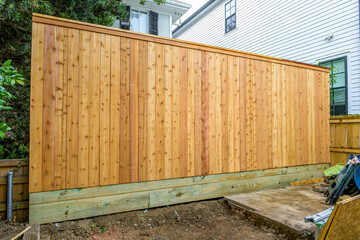 Newly Constructed 10 ft. Wooden Fence in Backyard of Residential Neighborhood