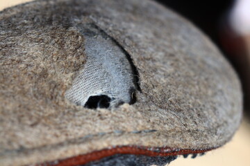Fototapeta premium A close-up view of a hat with a hole in it, suitable for use in illustrations about fashion or everyday life