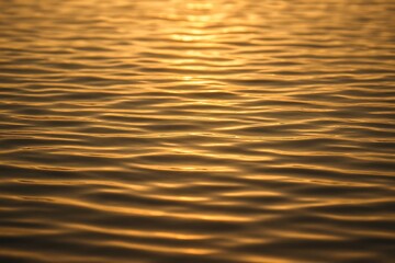 Golden Sunset Reflections on Tranquil Water Surface