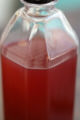A close-up view of a bottle filled with a clear liquid, suitable for use in a medical or scientific context