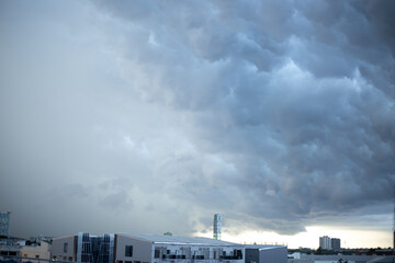 Dark blue sunlight sunset sky background with rain cloud and town building in evening of the day landscape skyscape 