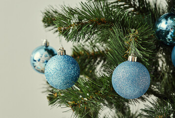 A Christmas tree decorated with a variety of blue ornaments.