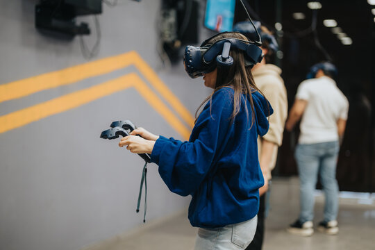 A close-up image of friends in a virtual reality gaming session, wearing VR headsets and holding controllers, exploring an immersive and engaging experience in a fun social setting.
