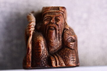 A person holds a ceramic or plastic bird as a decorative figurine