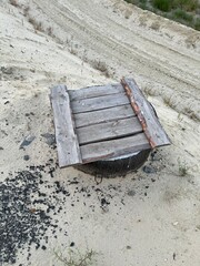A well made of reinforced concrete rings covered with a wooden deck. Construction, drainage