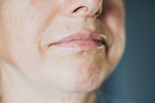 an elderly woman in a blue blouse - Powered by Adobe